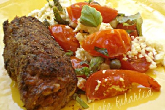 Steaks with pesto, tomatoes and feta cheese